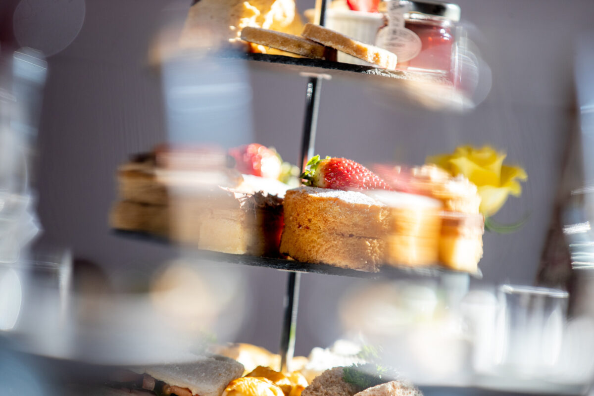 photo looking through a wine glass during afternoon tea photo looking through a wine glass during afternoon tea